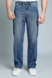 Person wearing blue jeans on a gray background