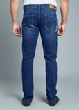 Blue jeans worn by a person on a gray background