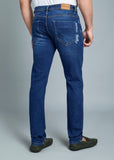 Person wearing blue jeans on a gray background