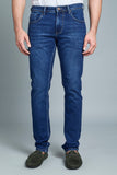 Person wearing blue jeans on a gray background